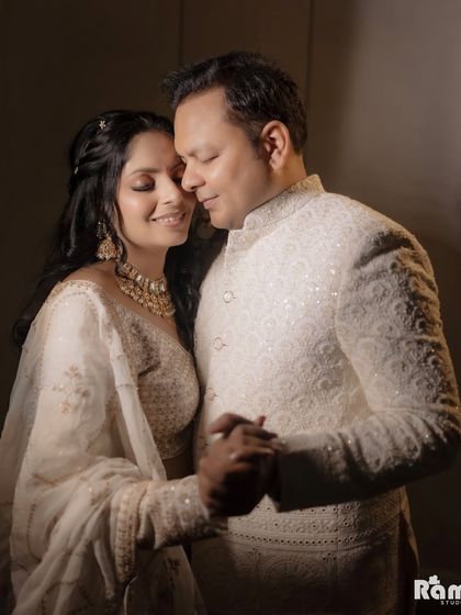 An engagement portrait captured with soft, warm light. The focus is on the couple's gentle dance and happy expressions, highlighting the joy and intimacy of their relationship.