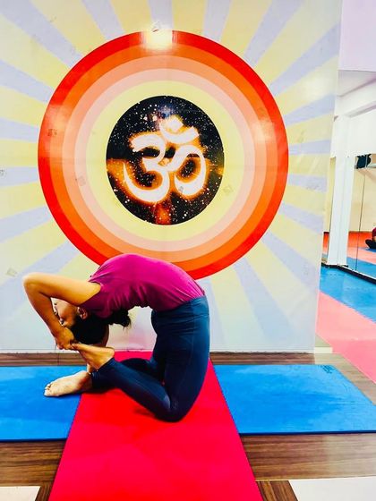 A student in Kapotasana, showcasing the deep spinal flexibility that can be achieved with consistent and safe practice.