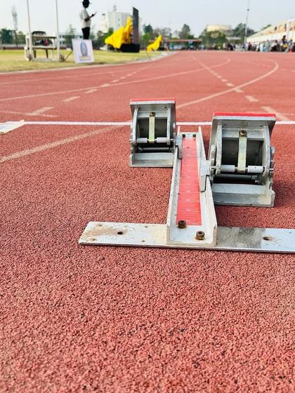 The starting blocks signify the beginning of a beautiful journey, where dreams take flight and champions emerge.