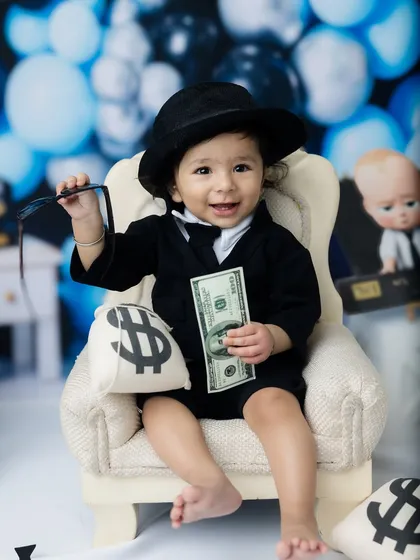 A winning smile from this little executive. The "Boss Baby" theme is perfect for a memorable first birthday or milestone shoot.