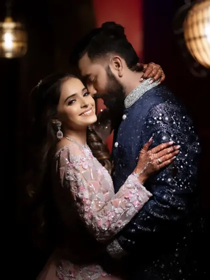 An intimate embrace in a warmly lit room. The soft lighting and their close connection create a cozy and romantic mood, perfect for capturing the tender side of a couple's love story.