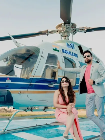 Making a grand entrance into their new life together. This stylish shot from a helicopter pre-wedding shoot in Pune is the definition of luxury and modern romance, creating an unforgettable memory.