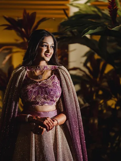 For a sangeeth night, we can have a bit more fun with the look. This modern, glittery style with a stunning cape lehenga shows how we can create a glamorous and photo-ready look perfect for dancing the night away.