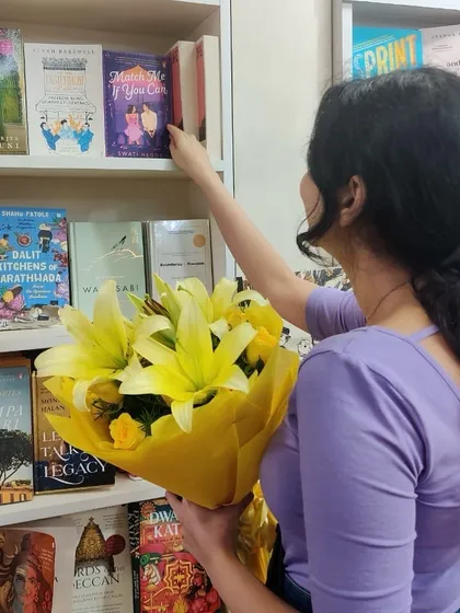 A photo from my debut month, placing a copy of *Match Me If You Can* on a bookstore shelf. It's been an incredible six months since its release.