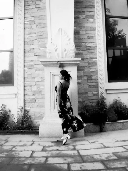 A black and white series exploring different poses against architectural elements. These shots focus on form, light, and the interaction between the subject and her environment.