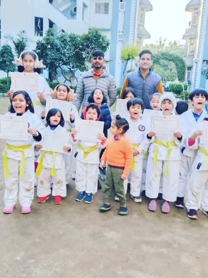 Outdoor training session with our little champions. They are shouting with joy after receiving their certificates.