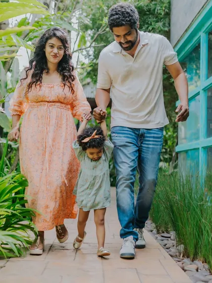 Mom, Dad, and Me. This family is taking a happy walk, celebrating their daughter's second birthday milestone.