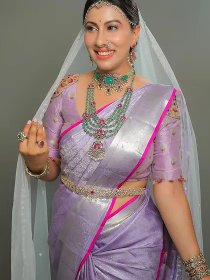 The sheer veil adds a touch of mystery and romance to this stunning bridal look.
