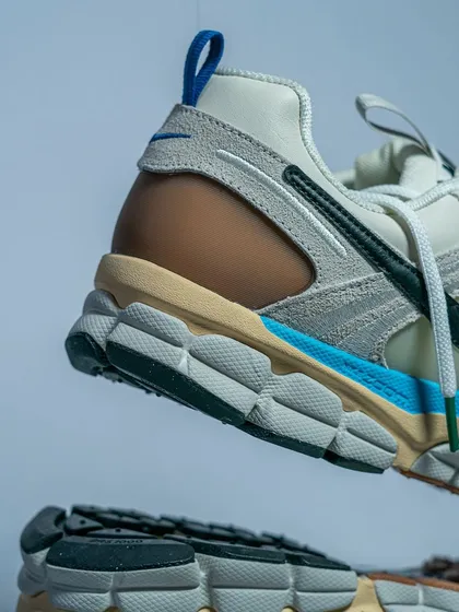 A floating shot of the Nike Zoom Vomero 5, emphasizing the Cushlon and Zoom Air sole unit that makes it so comfortable.
