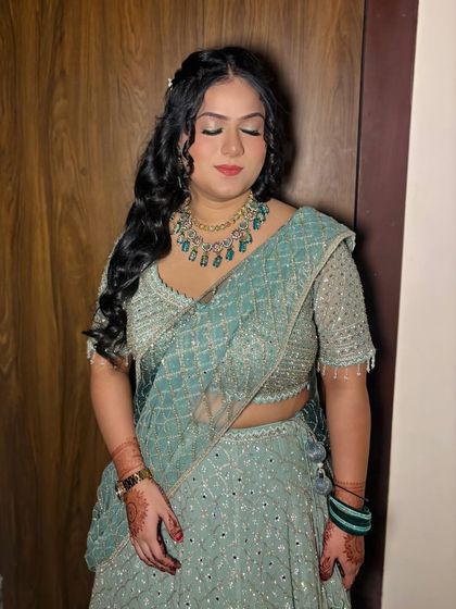 A close-up with eyes closed, showing the beautiful makeup.