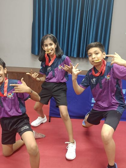 Our junior team celebrating with their medals after winning the team events at the BUDTTA tournament. Teamwork and camaraderie are key values at our academy.