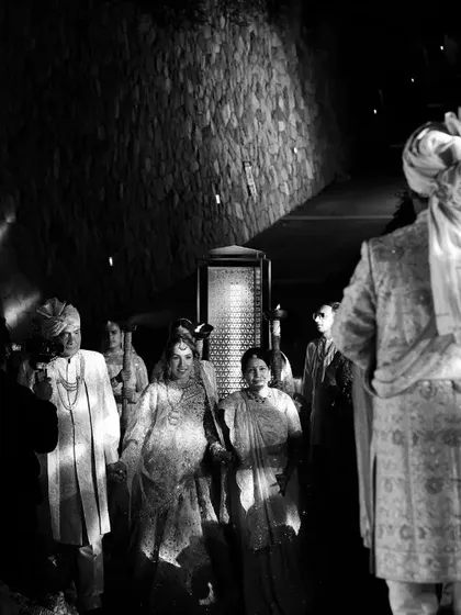 A dramatic black and white shot of the groom waiting for his bride, capturing the anticipation of the moment.