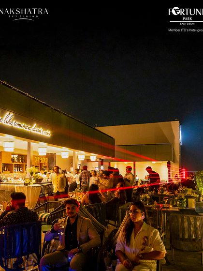 The rooftop buzzes with energy during our launch event, with laser lights adding to the celebratory atmosphere.