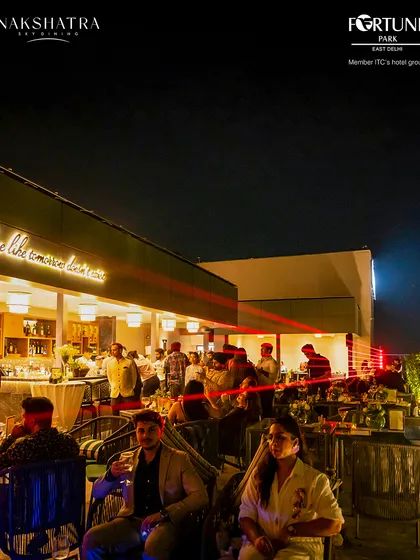 The rooftop buzzes with energy during our launch event, with laser lights adding to the celebratory atmosphere.