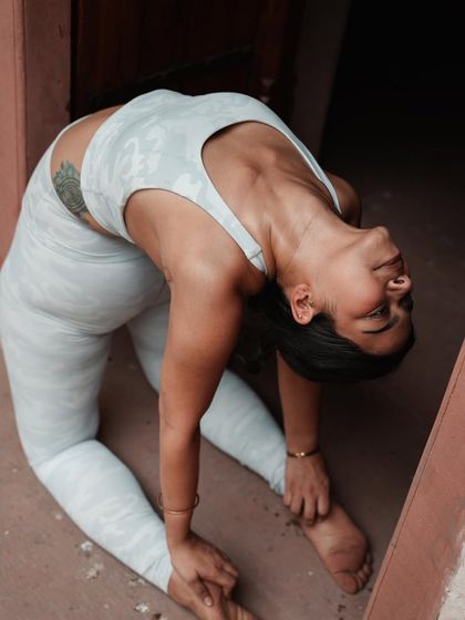 A different perspective of Camel Pose, focusing on the deep backbend. It's okay to fall and try again; that's how we learn and grow.