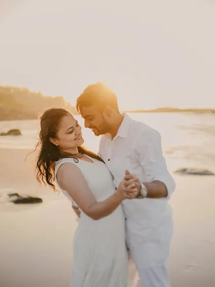 A romantic dance on the beach at sunset. The golden light and their joyful movements make this a perfect shot for a couple who loves the sea.