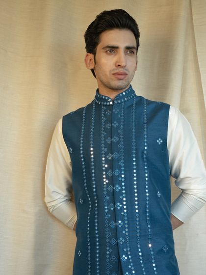 A symphony of blue hues and exquisite craftsmanship. This stunning menswear ensemble embodies timeless sophistication.