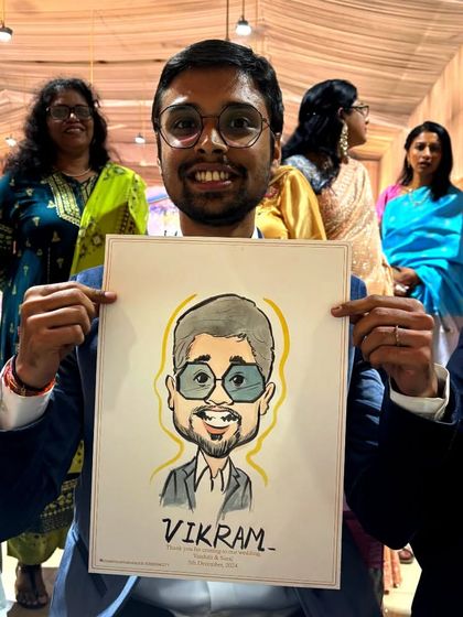 A guest at a wedding proudly displays his caricature, a great example of a personalized event souvenir.