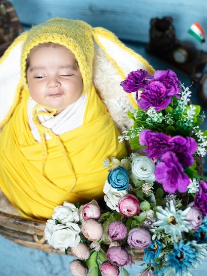 This little bunny is sleeping peacefully, surrounded by flowers and vintage props.