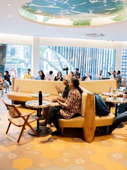 A wide shot of the audience interacting and listening at the "Wheel of Life" event, capturing the community feel of our gatherings.