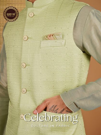 Celebrating culture in fabric. A close-up on a lime green textured Nehru jacket, focusing on the pocket square and fabric detail.