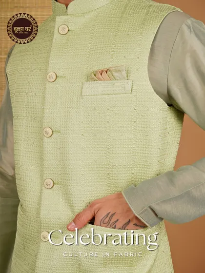 Celebrating culture in fabric. A close-up on a lime green textured Nehru jacket, focusing on the pocket square and fabric detail.