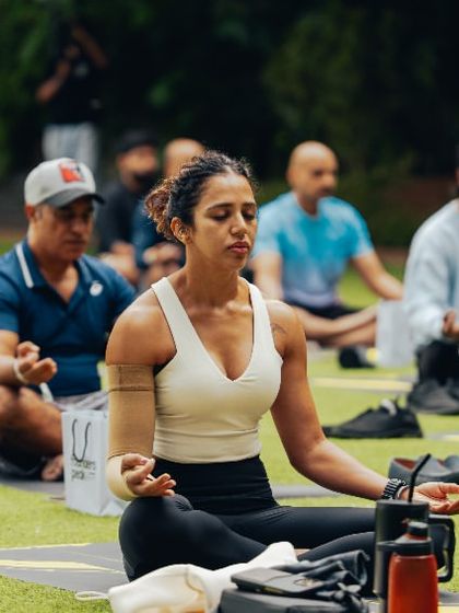 Participants find their focus during a group meditation session, part of a corporate wellness retreat held on our grounds.