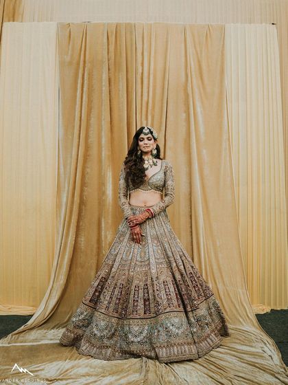 Another stunning full-length shot, where the lehenga is spread out, creating a grand and royal image.