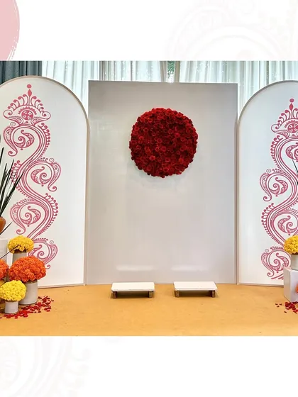 For this Aashirwad ceremony, I designed a backdrop inspired by a Bengali bindi, using a circle of red roses against a clean white panel.