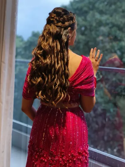 A hairstyle should be a work of art. This intricate combination of braids and soft curls not only looks beautiful from the back but is also designed to stay perfect through a night of dancing.