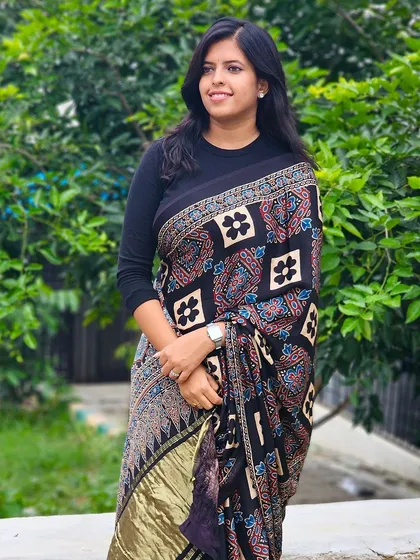 Another shot of a client enjoying her Ajrakh saree. The rich patterns and the golden tissue patti on the pallu make it a standout piece.