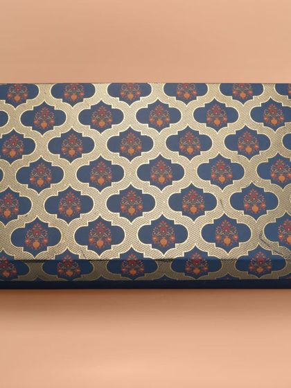 A long rectangular box with a royal blue and gold traditional Indian pattern. We ensure patterns are sharp and colors are true to life.