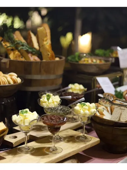 An artisanal bread and butter station, featuring a variety of freshly baked breads, breadsticks, and flavoured butters. This is a simple yet elegant addition to any buffet or sit down dinner.