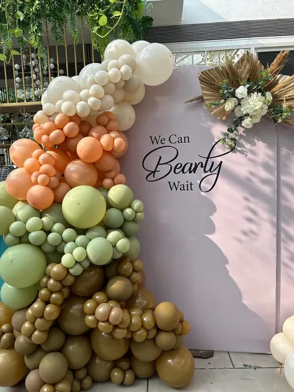 The beautiful texture and color gradient of the balloon arch, complemented by dried pampas grass and floral arrangements for a boho-luxe feel.