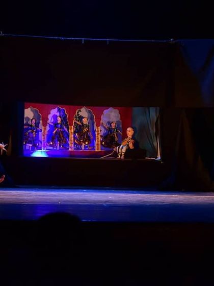 The stage is set to create a world of royalty and romance. This wide shot shows a live dancer in motion, with the puppet characters providing context and depth from their own stage, a technique we use to create a multi-dimensional performance.