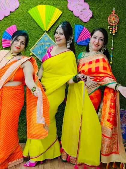 Three of our lovely members posing in their beautiful traditional attire for our Teej celebration.