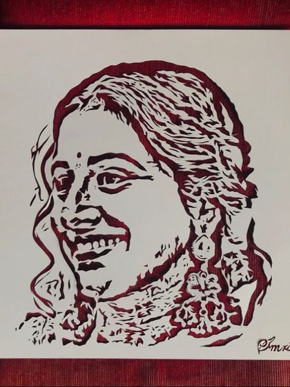 The finished paper-cut portrait of Vidya Balan, cut from a beautiful red paper. You can choose the color of the paper to match your style or the mood of the photo.