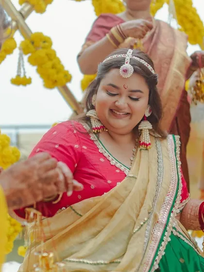 Another beautiful moment from the Haldi. The focus is on her happy, glowing expression, enhanced by a subtle and elegant makeup application.