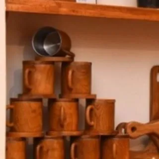 I believe even everyday items should feel special. This stack of handcrafted teak mugs, some lined with steel for durability, shows how the natural warmth and grain of the wood can elevate your daily coffee or tea ritual.
