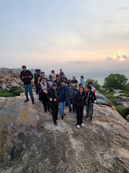 The group walking along the summit of Anthargange as the morning sun casts a warm glow.