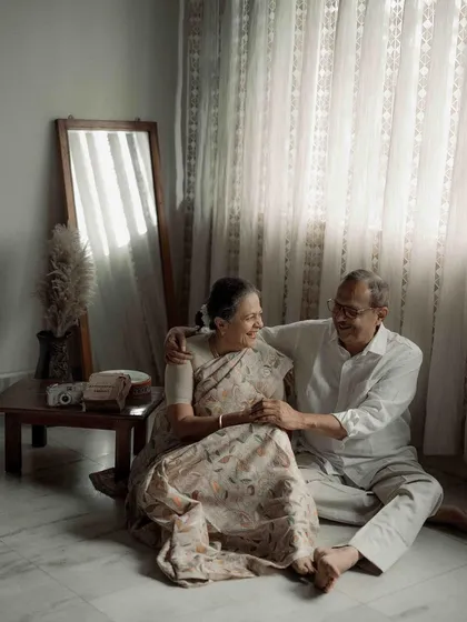 Seated together in the soft light of their home, their comfort with each other is palpable. My aim was to create a portrait that felt as warm and familiar as their love.