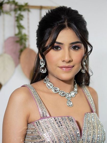 A close-up of a half-up style with soft tendrils framing the face.