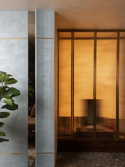 The pooja room, designed as a serene sanctuary. We used fluted glass panels set in delicate metal frames to create a sense of privacy while allowing light to filter through, resulting in a space that feels both sacred and modern.