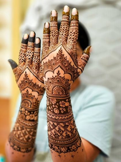 The palms are a canvas for the most detailed work. Here you can see the intricate mandalas and patterns that form the heart of the design.