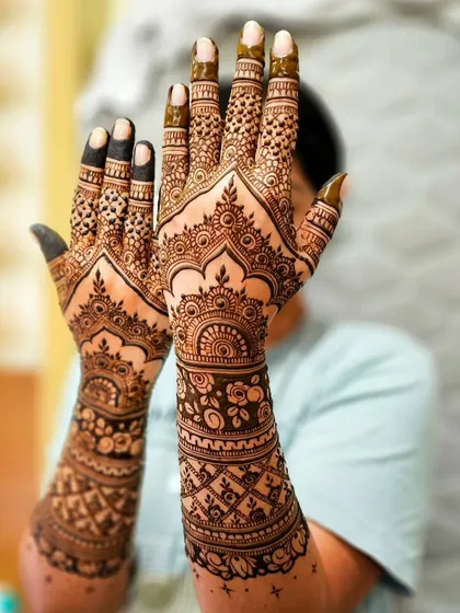 The palms are a canvas for the most detailed work. Here you can see the intricate mandalas and patterns that form the heart of the design.