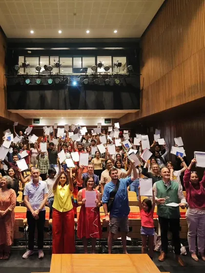 Participants proudly holding up their certificates after the "La Dictée pour Tous" event. Congratulations to everyone who took part!