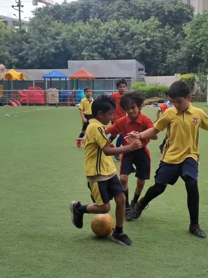 Two players challenge each other for possession of the ball, demonstrating the competitive yet fair spirit of our inter-house matches.