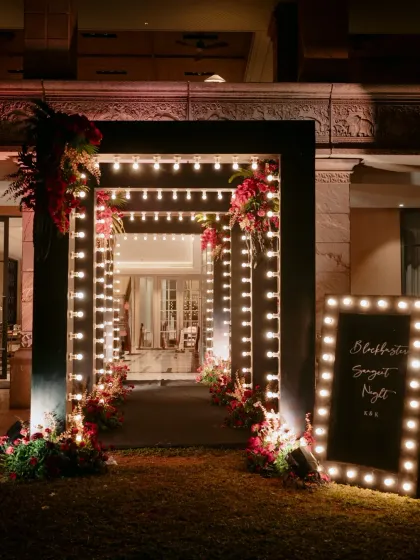 The entrance to an event is the first chapter of the story. This glamorous, light-bulb-framed tunnel set an exciting, "red carpet" tone for the sangeet night ahead.