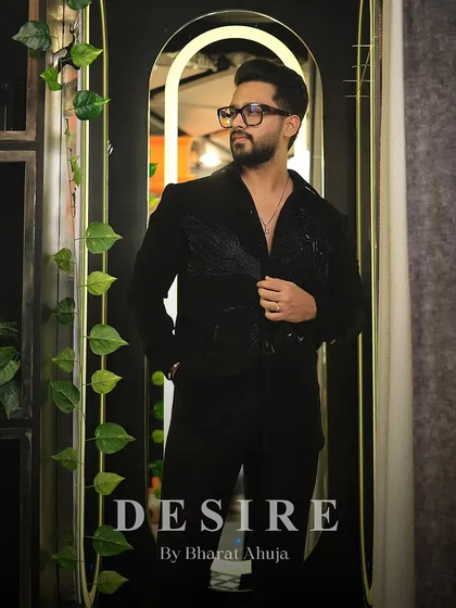 Wearing black like a weapon. This image shows the full silhouette of the black-on-black embroidered shirt, a testament to sharp lines and designer threads.