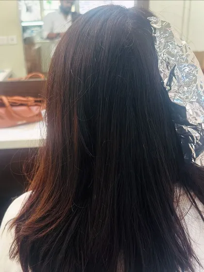 The process of creating a chocolate California brunette look. Here you can see the foils being used to add subtle highlights.